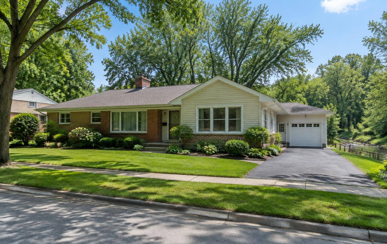 Single-story brick ranch home with a shingle roof
