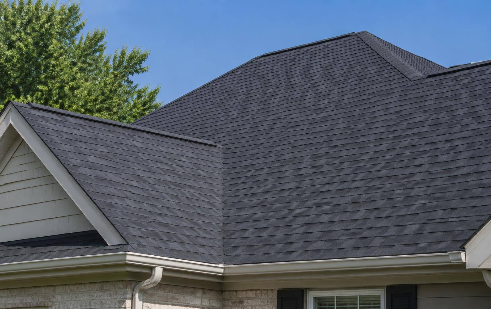 Dark asphalt shingle roof on a suburban home