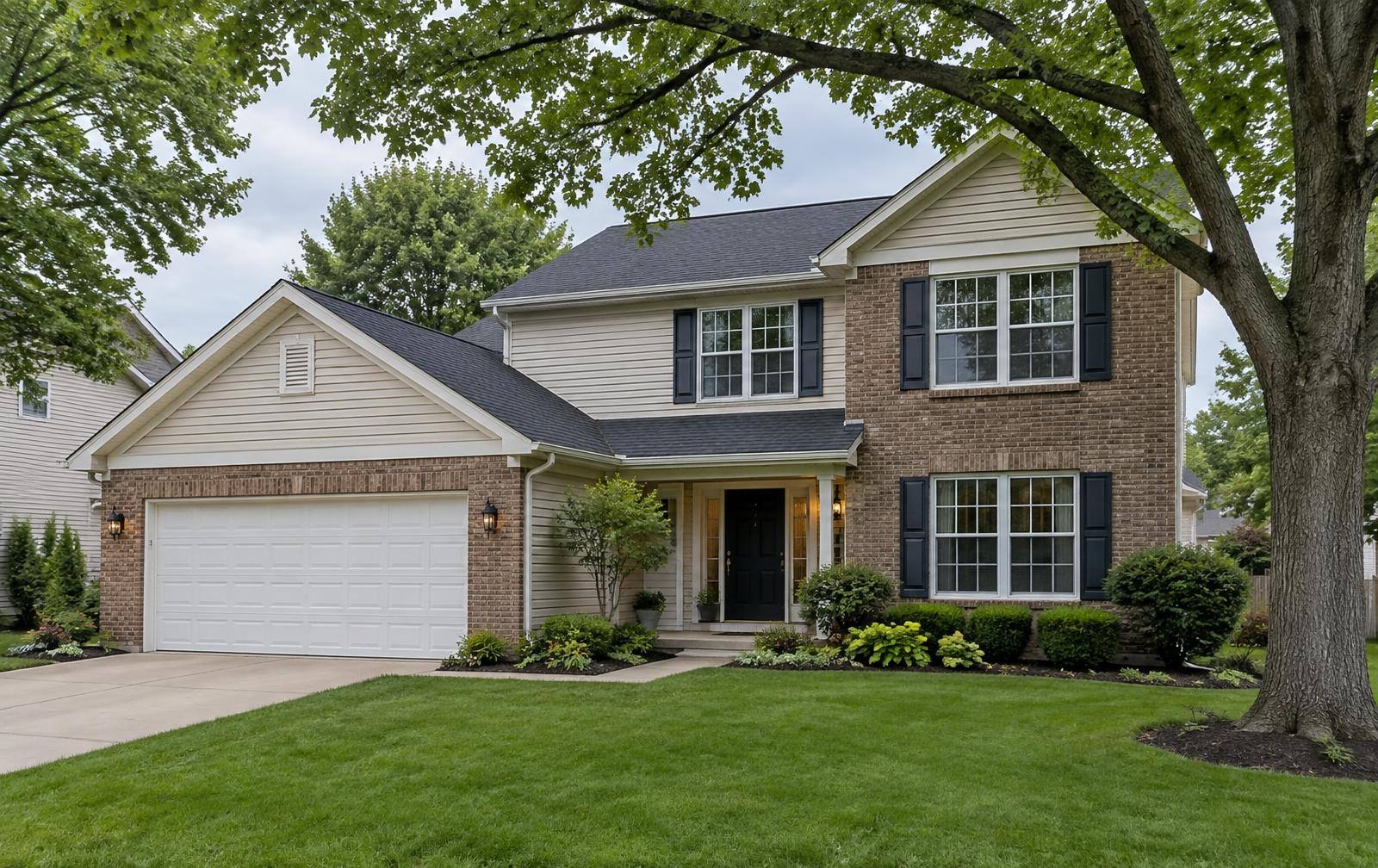 Two-story home with light siding and a brick front